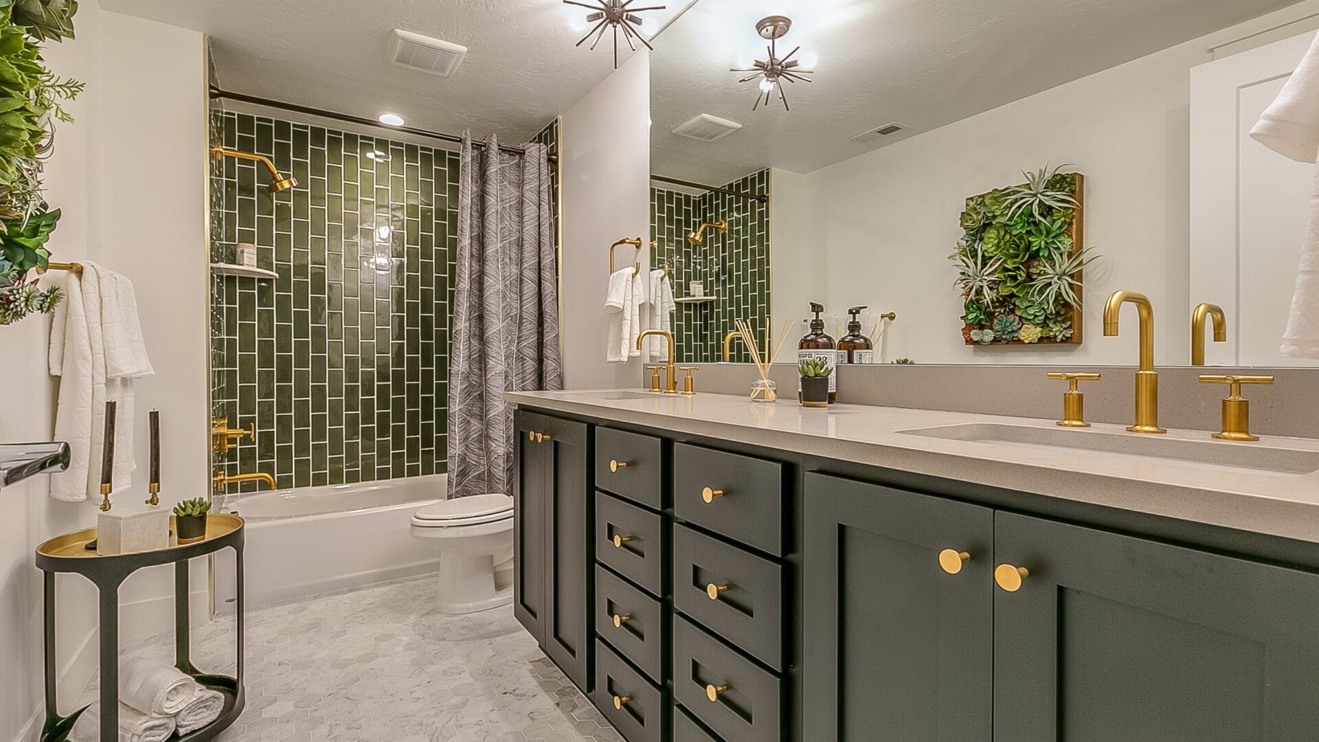 Green is the theme in this beautiful bathroom with brass faucets and fixtures